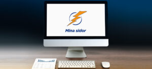 Skrivbord med en dator, tangentbord, läsplatta och datormus.
